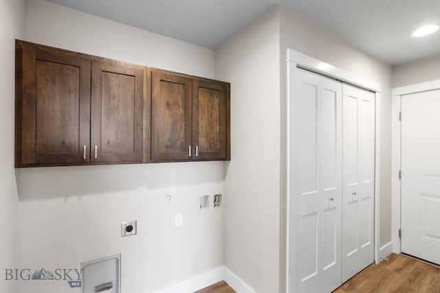 washroom featuring cabinet space, baseboards, light wood-style flooring, hookup for an electric dryer, and washer hookup