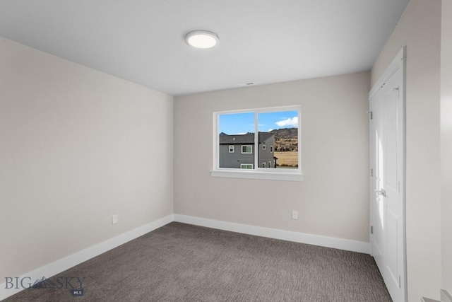 unfurnished bedroom featuring carpet flooring and baseboards