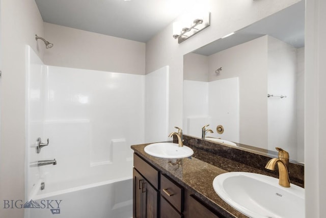 full bathroom featuring double vanity, shower / tub combination, and a sink