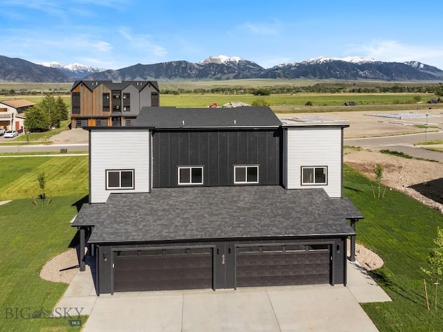 view of front of house featuring a garage, a mountain view, concrete driveway, and roof with shingles