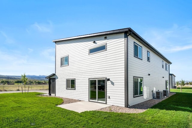 back of house with a yard and central AC unit