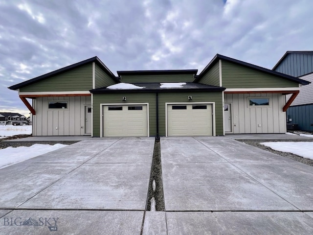 view of front of house featuring concrete driveway, board and batten siding, and an attached garage