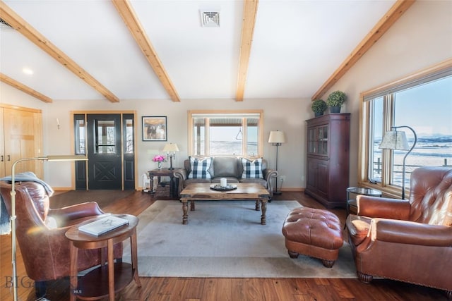 living room with vaulted ceiling with beams, wood finished floors, visible vents, and baseboards