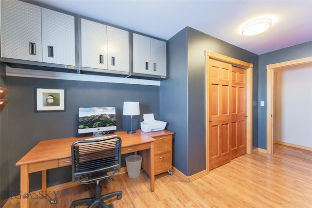 office with baseboards and light wood finished floors