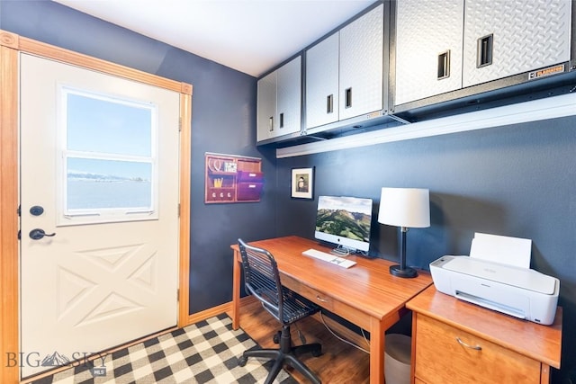 office area with baseboards and wood finished floors