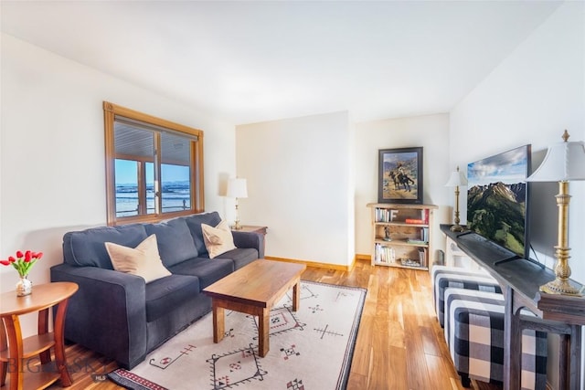 living room with baseboards and light wood-type flooring