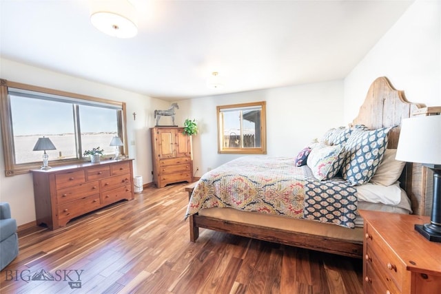 bedroom featuring baseboards and light wood-style flooring