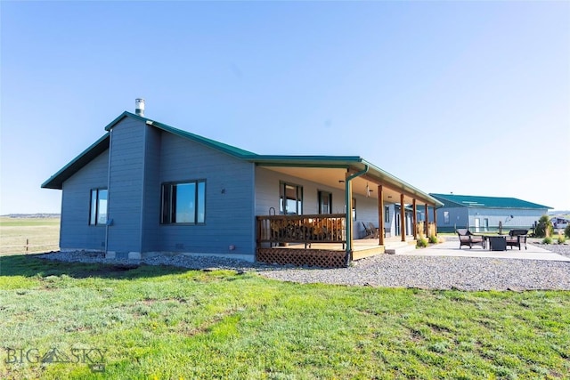 42 Jim Parrent Ln, Big Timber, MT 59011 - back of property featuring a lawn, a patio area, and an outdoor fire pit