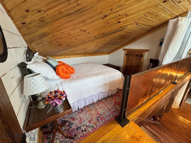 bedroom featuring lofted ceiling, hardwood / wood-style floors, and wood ceiling