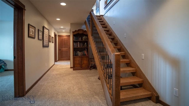 stairway featuring baseboards, carpet, and recessed lighting