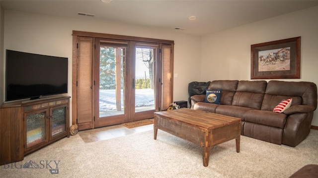 tiled living area featuring carpet floors and visible vents