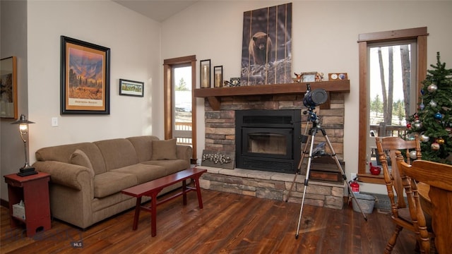 living area with wood finished floors and a stone fireplace