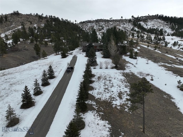 snowy aerial view featuring a mountain view