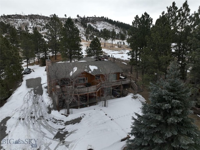 snowy aerial view featuring a mountain view