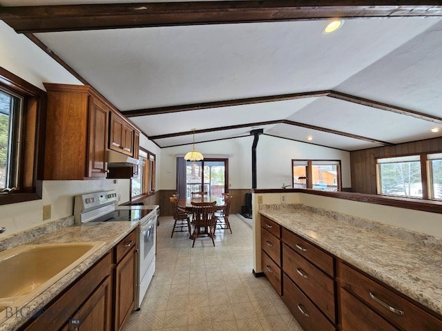 kitchen featuring a wainscoted wall, electric range, a sink, and vaulted ceiling with beams