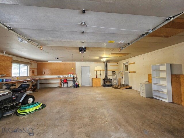 garage with a wood stove and a garage door opener