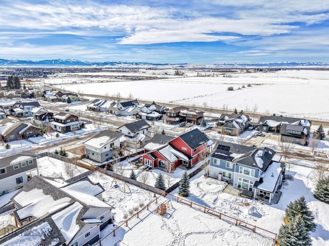 snowy aerial view with a residential view