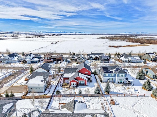 snowy aerial view featuring a residential view