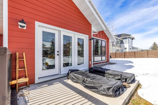 snow covered patio with fence