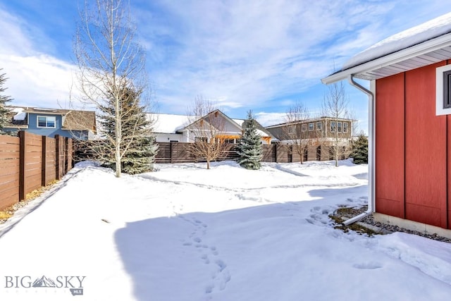 yard covered in snow featuring a fenced backyard