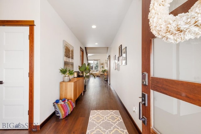 hall featuring dark wood-style floors, recessed lighting, and baseboards