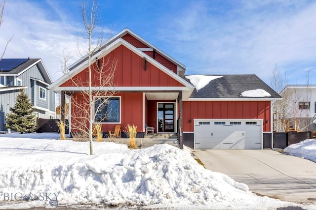 chalet / cabin featuring board and batten siding, driveway, and a garage