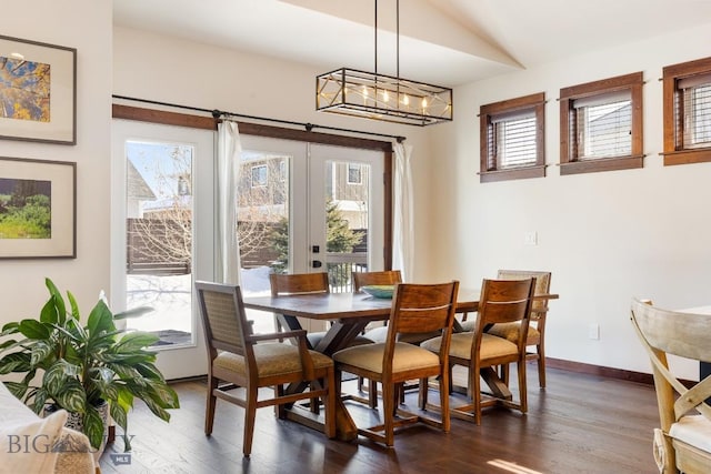 dining room with dark wood-style flooring, a wealth of natural light, and french doors