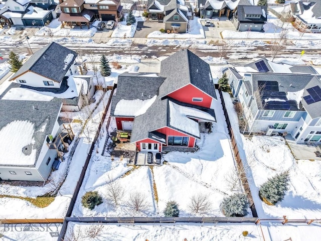 snowy aerial view featuring a residential view