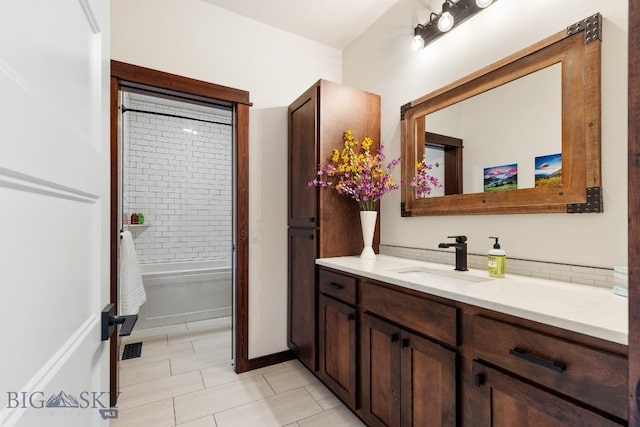 bathroom with tile patterned floors, a washtub, and vanity