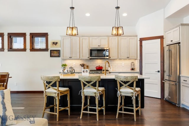 kitchen with tasteful backsplash, stainless steel appliances, a sink, and light countertops