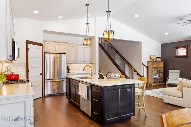 kitchen with dark wood-style floors, light countertops, appliances with stainless steel finishes, and a sink