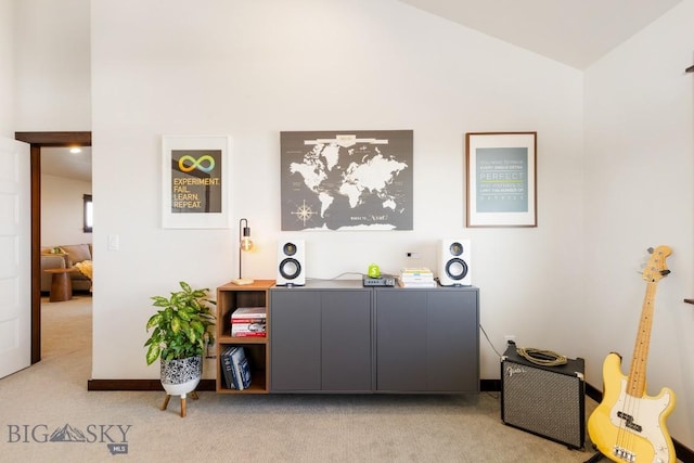 interior space with carpet and lofted ceiling