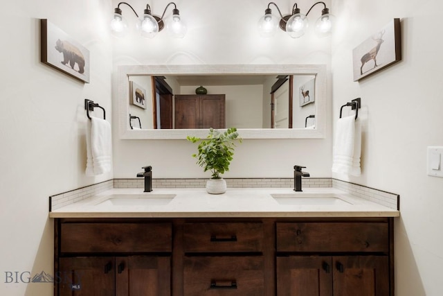 full bathroom with double vanity and a sink