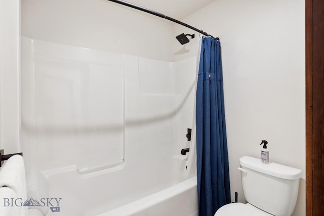 bathroom featuring shower / tub combo and toilet