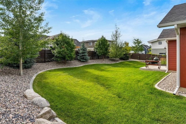 view of yard with a fenced backyard and a patio