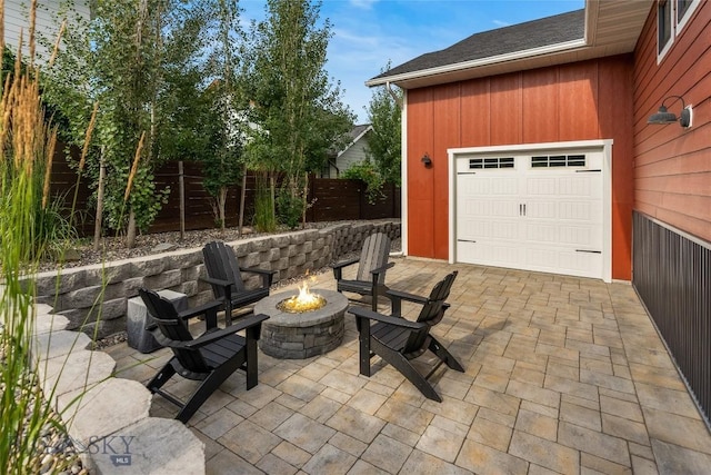 view of patio / terrace with an outdoor fire pit and fence