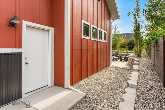 view of side of home with fence and a patio