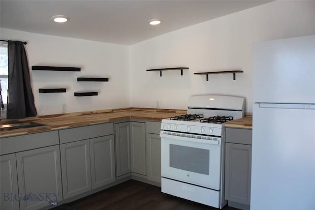 kitchen with open shelves, white appliances, gray cabinets, and wooden counters