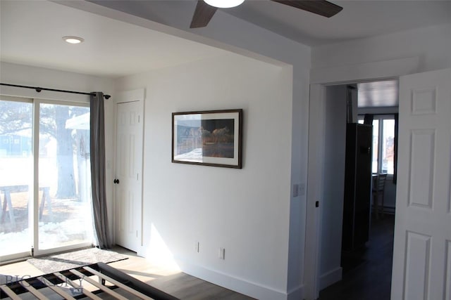 spare room with a ceiling fan, baseboards, wood finished floors, and recessed lighting