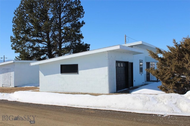 view of front facade with concrete block siding