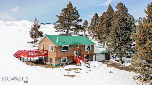 split foyer home featuring a deck and an attached garage