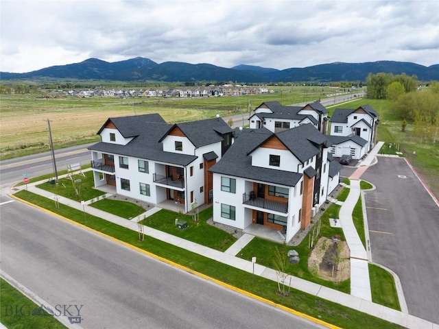 drone / aerial view featuring a residential view and a mountain view