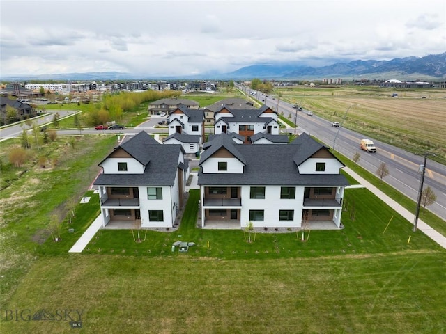 drone / aerial view featuring a residential view and a mountain view