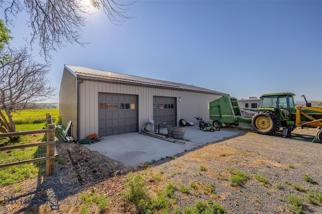 detached garage featuring fence
