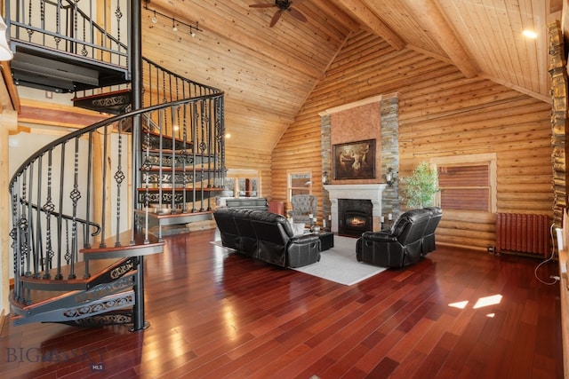 living room featuring a stone fireplace, wooden ceiling, stairway, and radiator heating unit