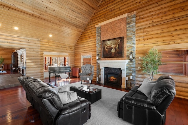 living area with a lit fireplace, high vaulted ceiling, hardwood / wood-style floors, and log walls