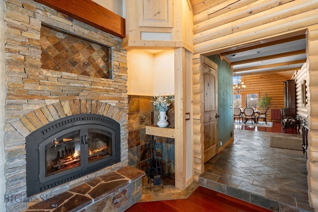 interior space featuring a stone fireplace, rustic walls, and wood finished floors