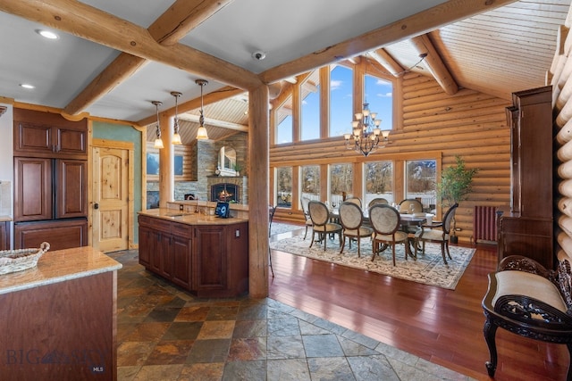 kitchen with high vaulted ceiling, plenty of natural light, a chandelier, and beamed ceiling