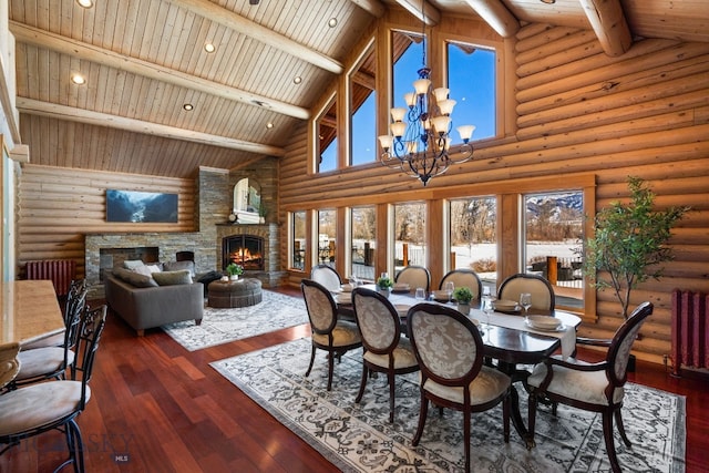 dining area featuring beam ceiling, dark wood finished floors, recessed lighting, a stone fireplace, and a chandelier