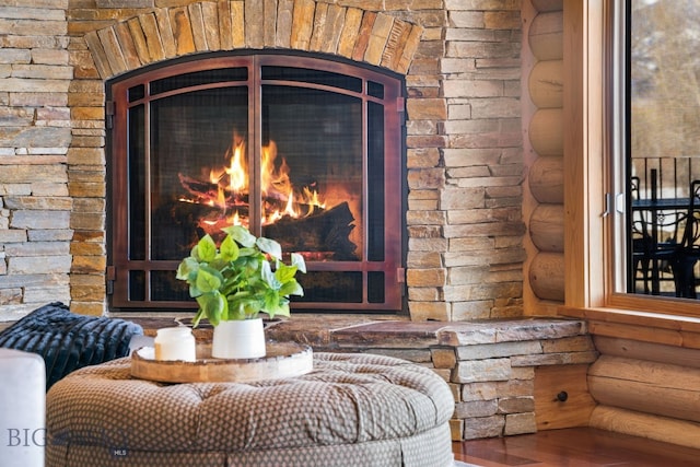 details with rustic walls and a lit fireplace